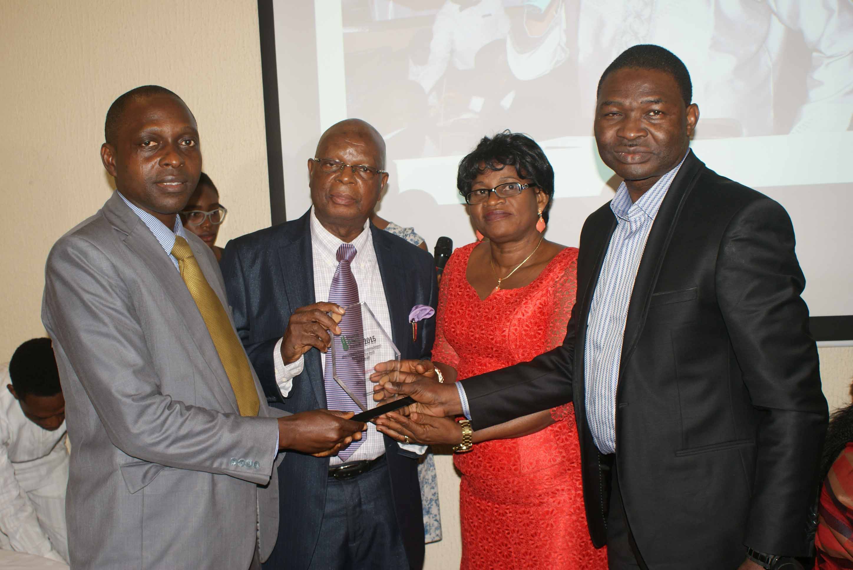 Dr. Josiah Ebhomenye of Market Trends receives award from Mr. Feyisola, MD, Media Stamp